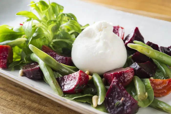 Burrata with roasted beets, mache, string beans and pine nuts<br>